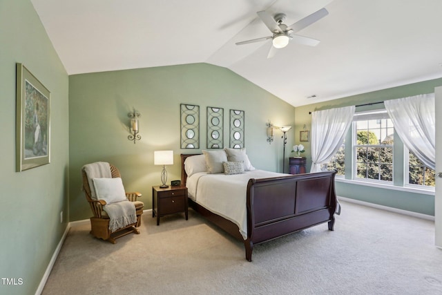 bedroom with light carpet, visible vents, baseboards, a ceiling fan, and vaulted ceiling