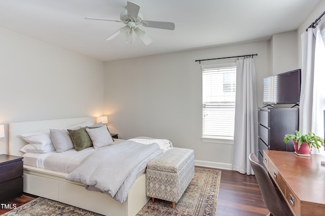 bedroom featuring dark wood-type flooring, a ceiling fan, and baseboards