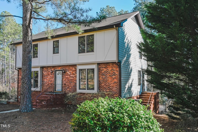 view of front of house featuring board and batten siding and brick siding