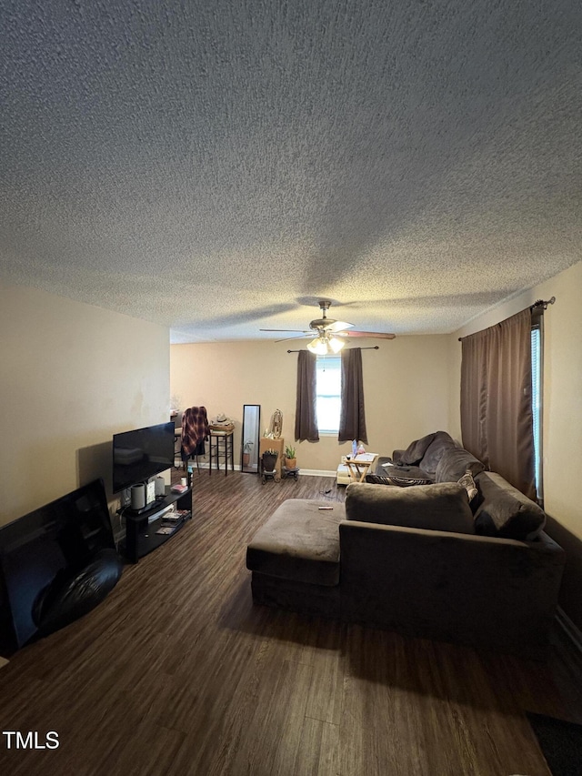 bedroom with ceiling fan, a textured ceiling, and wood finished floors