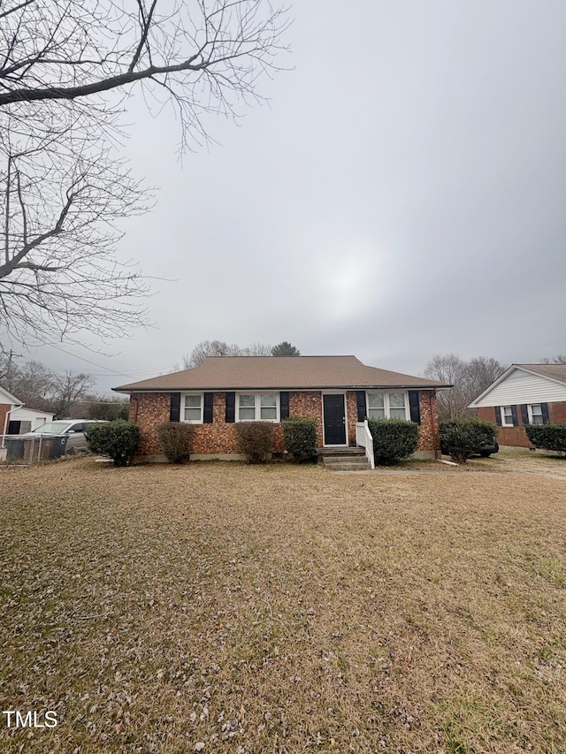 view of front of home with brick siding and a front yard