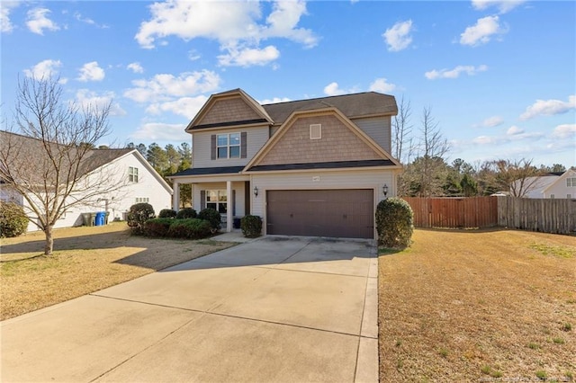 craftsman-style house featuring a front lawn and a garage