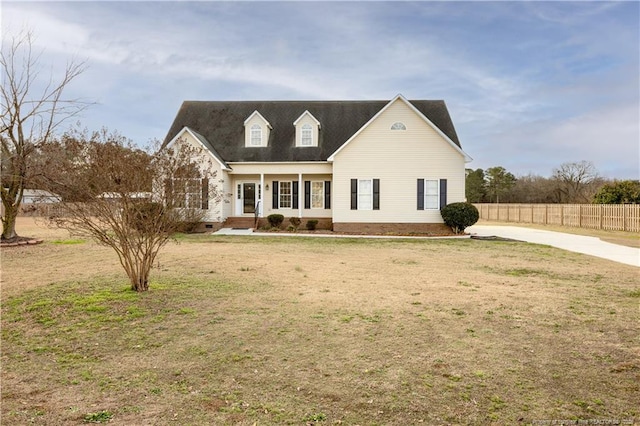 cape cod home with a front yard, crawl space, covered porch, and fence