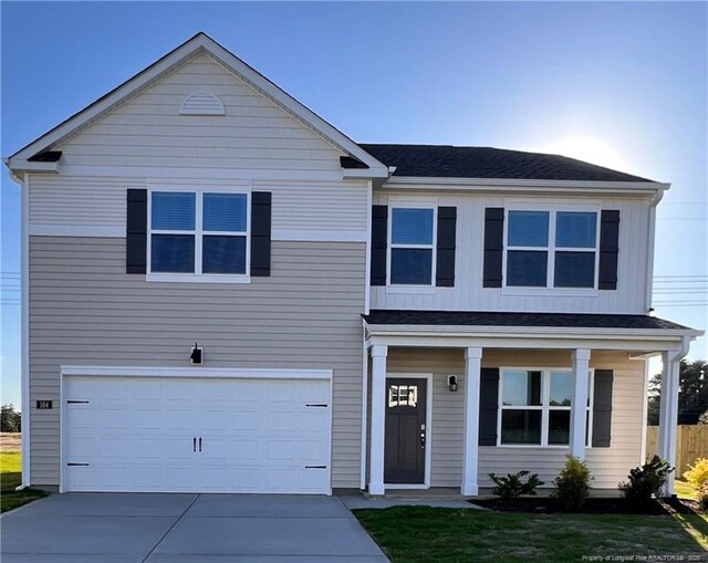 184 Hartfield Ave, Raeford, NC 28376 - traditional-style house featuring a garage, driveway, and covered porch