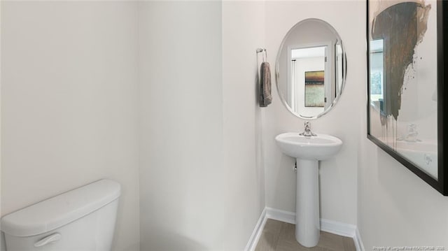 196 Hartfield Ave, Raeford, NC 28376 - half bathroom with toilet, baseboards, and a sink