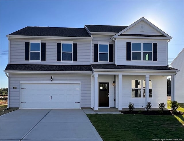 220 Hartfield Ave, Raeford, NC 28376 - view of front facade with concrete driveway, a garage, and a front lawn