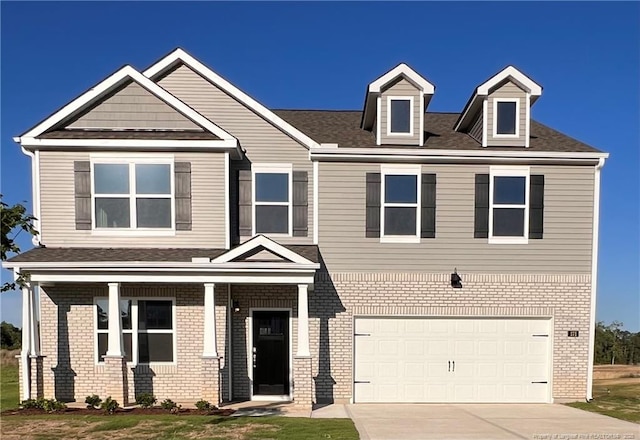 171 Hartfield Ave, Raeford, NC 28376 - view of front of home featuring driveway, a garage, brick siding, and roof with shingles