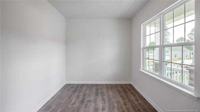 empty room with dark wood-type flooring