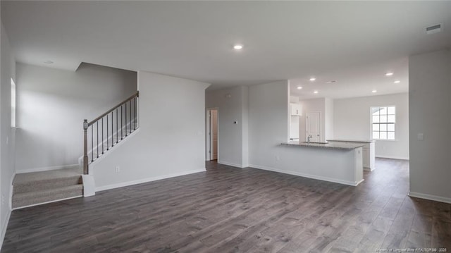 unfurnished living room featuring dark hardwood / wood-style floors