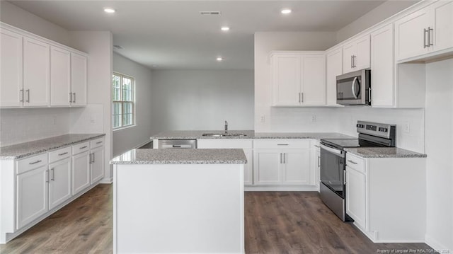 kitchen featuring white cabinets, appliances with stainless steel finishes, sink, and dark hardwood / wood-style flooring