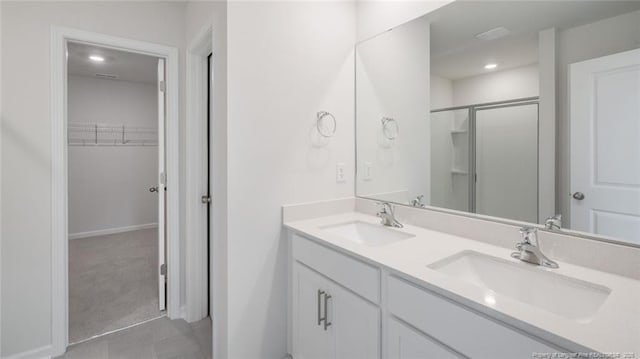 bathroom featuring vanity and a shower with door