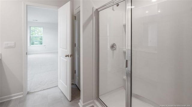 bathroom with a shower with door