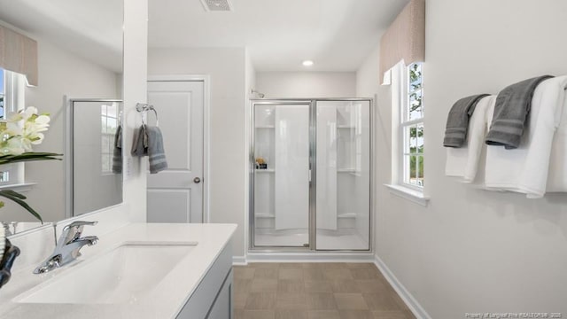 bathroom with vanity and a shower with door