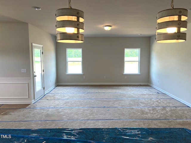 spare room with baseboards