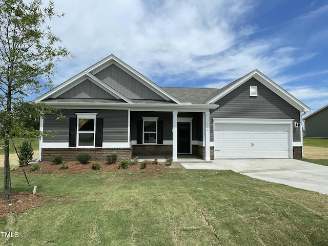 316 Olivia Crossing Ct Unit 11, Four Oaks, NC 27524 - view of front of home with driveway, an attached garage, a front yard, and brick siding