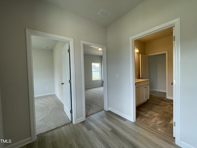 316 Olivia Crossing Ct Unit 11, Four Oaks, NC 27524 - hallway featuring light wood-style floors and baseboards