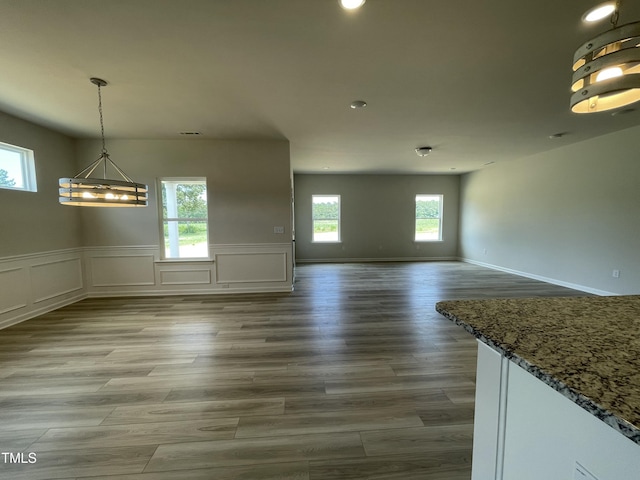 316 Olivia Crossing Ct Unit 11, Four Oaks, NC 27524 - unfurnished dining area featuring a chandelier, a wainscoted wall, recessed lighting, a decorative wall, and wood finished floors