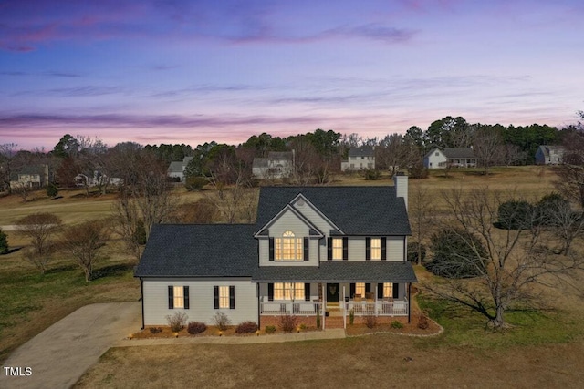 view of front of house featuring a porch and driveway