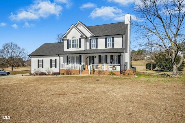 view of front of house featuring a porch, a front yard, a shingled roof, and a chimney