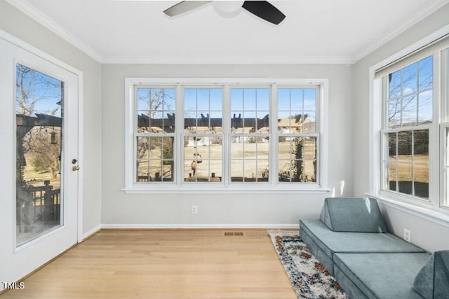 sunroom with visible vents and a ceiling fan