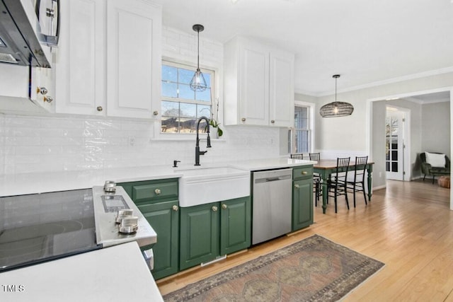 kitchen featuring light wood finished floors, green cabinets, stainless steel dishwasher, white cabinets, and a sink