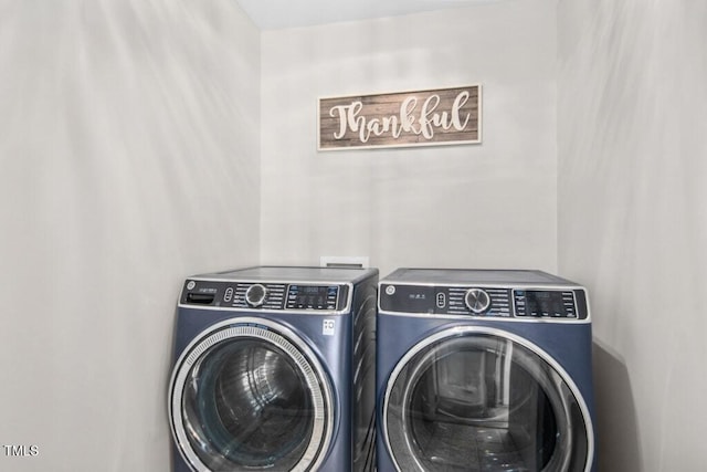 washroom featuring laundry area and washer and clothes dryer