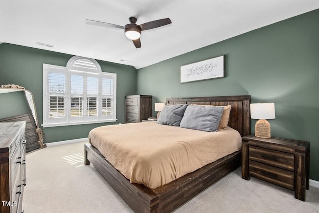 bedroom featuring ceiling fan, carpet flooring, visible vents, and baseboards