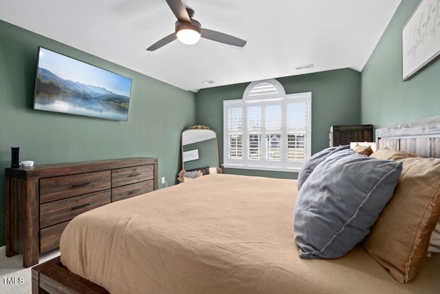 bedroom featuring ceiling fan, lofted ceiling, and visible vents