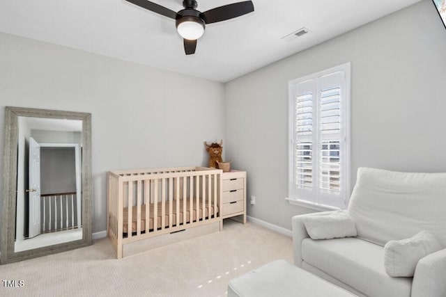 carpeted bedroom with visible vents, ceiling fan, baseboards, and multiple windows