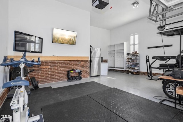 interior space with brick wall and baseboards