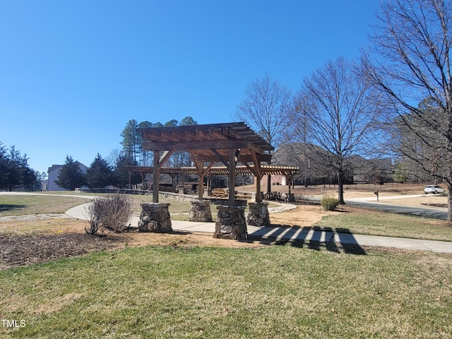 view of community with a lawn and a pergola