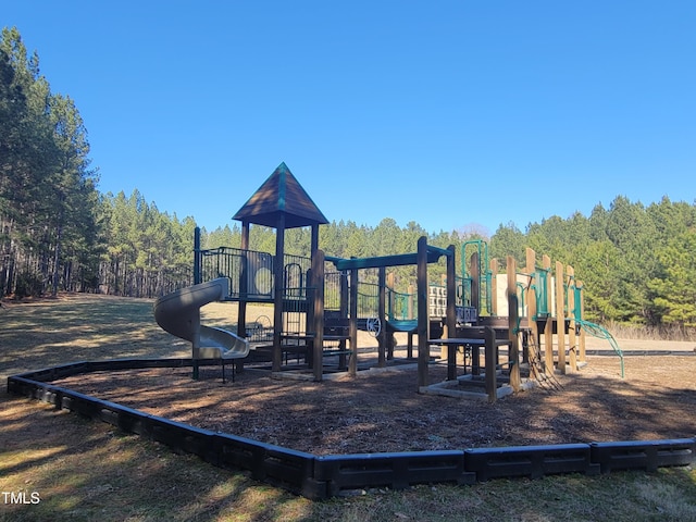 community jungle gym featuring a forest view