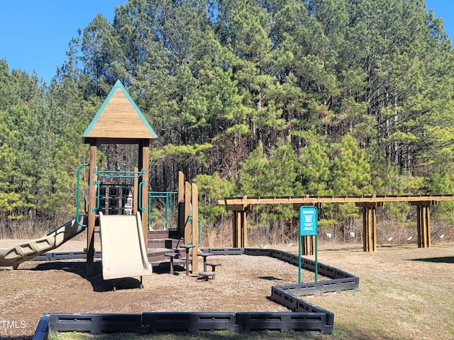 community jungle gym featuring a view of trees