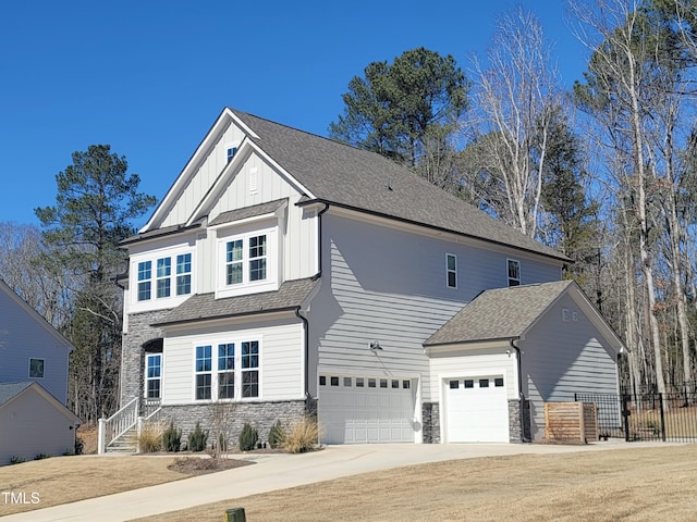 view of front facade featuring stone siding, board and batten siding, and a shingled roof