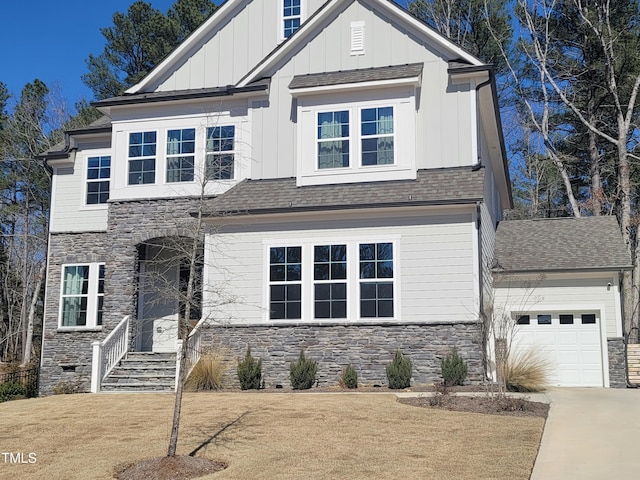 view of front of property with driveway, roof with shingles, a garage, stone siding, and board and batten siding