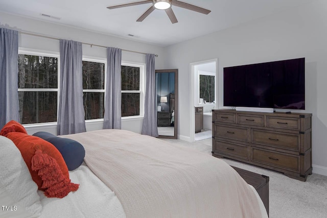 bedroom featuring visible vents, baseboards, light colored carpet, and a ceiling fan