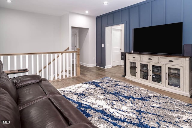 living area with recessed lighting, wood finished floors, and baseboards