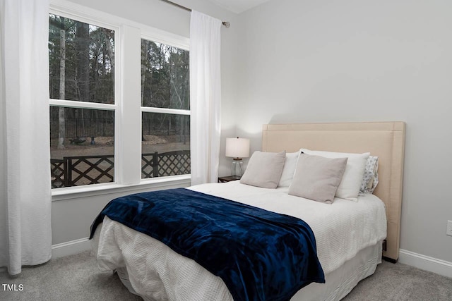 carpeted bedroom with baseboards