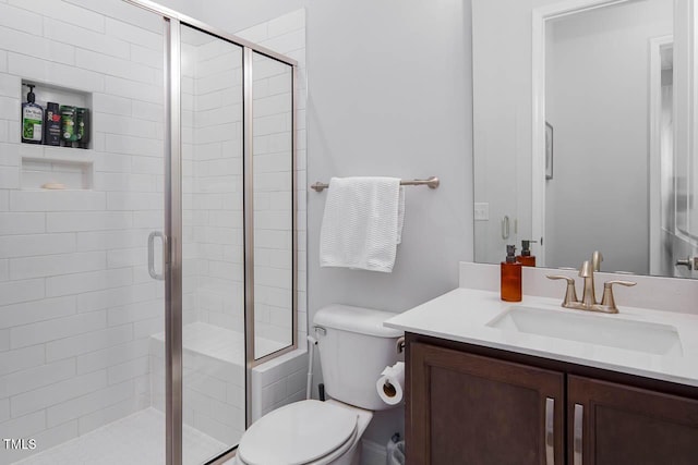 full bathroom featuring vanity, toilet, and a stall shower