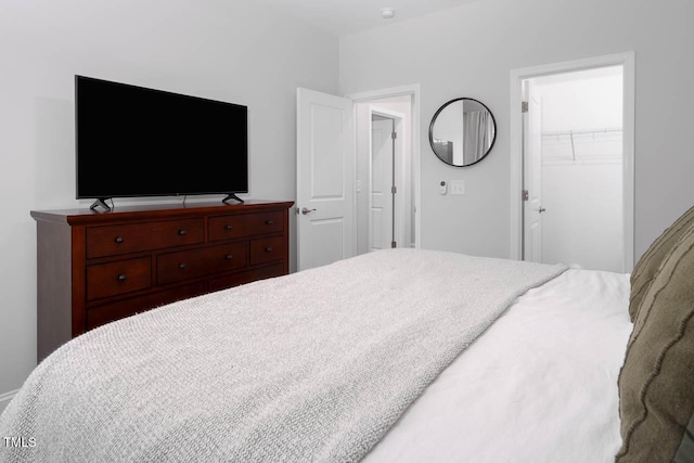 bedroom featuring a walk in closet and a closet