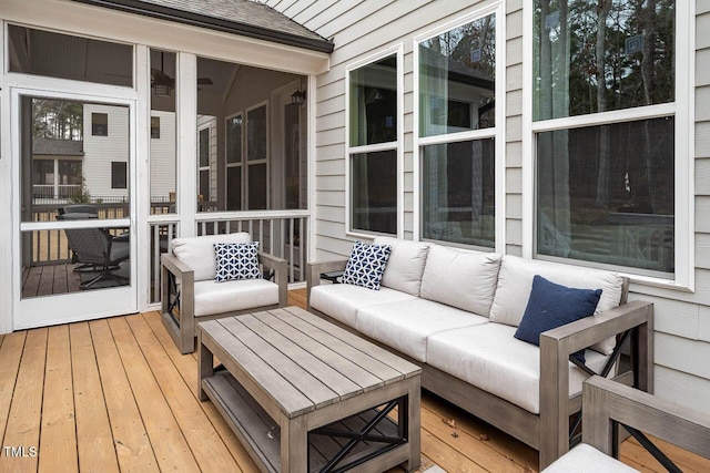 deck with a sunroom and an outdoor hangout area