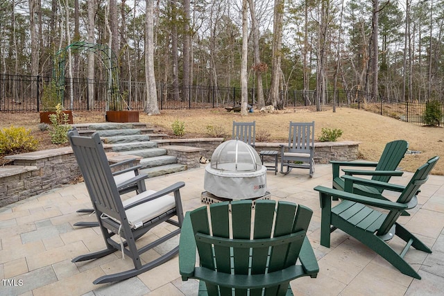 view of patio / terrace featuring an outdoor fire pit and a fenced backyard