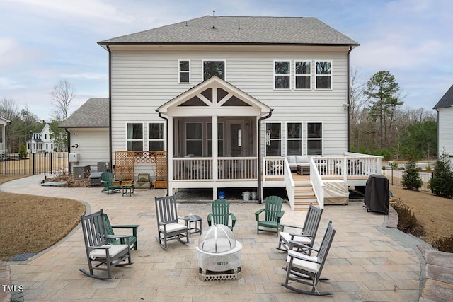 back of house with a patio, fence, a sunroom, and an outdoor fire pit