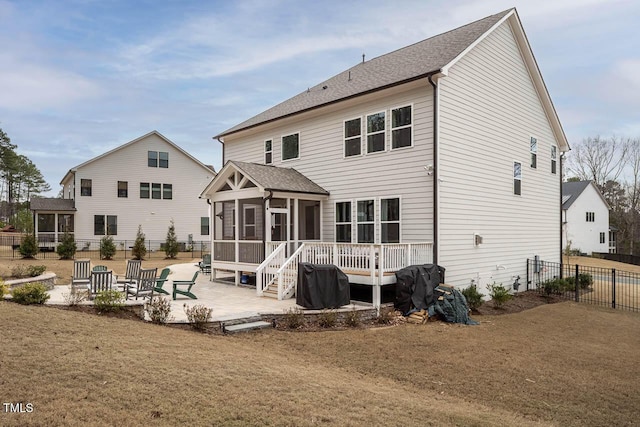 back of property featuring a patio area, fence, and a sunroom