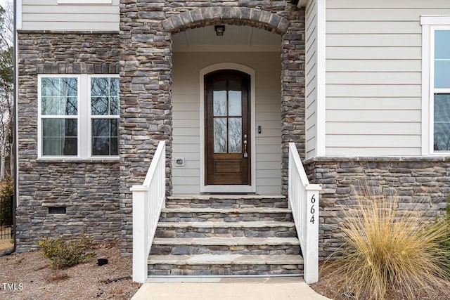 property entrance featuring crawl space and stone siding