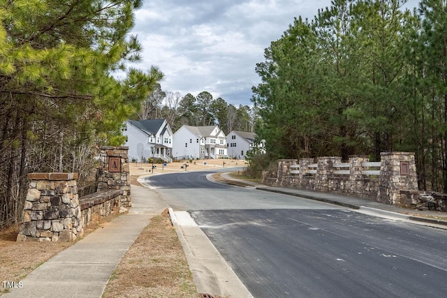 view of road with curbs, sidewalks, and a residential view