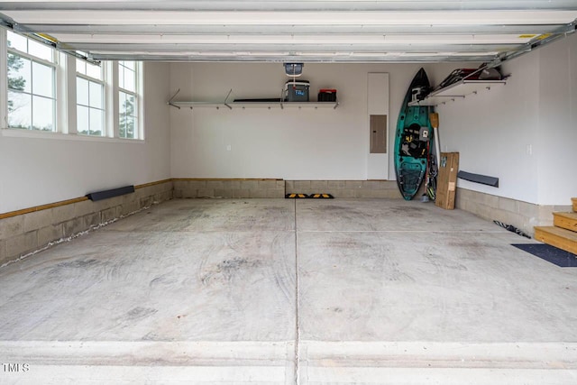 garage with electric panel and a garage door opener