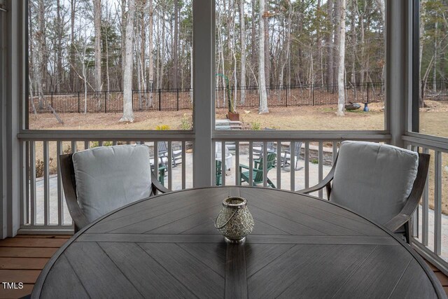 wooden terrace featuring outdoor dining area and fence