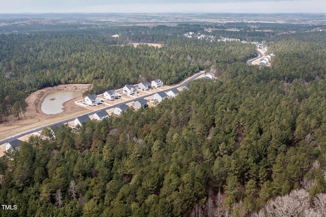 birds eye view of property featuring a forest view