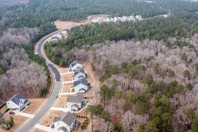 aerial view featuring a forest view and a residential view